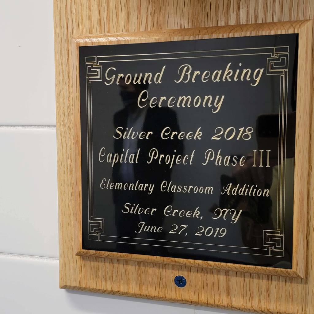 Groundbreaking Ceremony plaque from 2018 on the wall under the shovel makes note of the addition and date of June 27, 2019