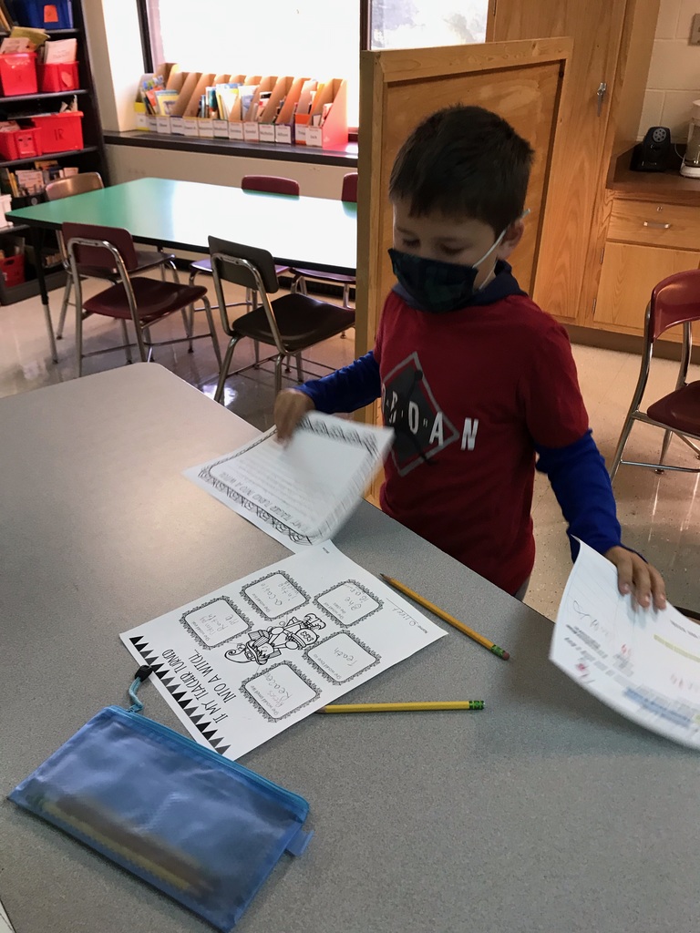 a masked student looks at his witch writing assignment