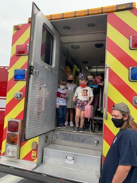 Students inside an emergency vehicle prepare to evacuate