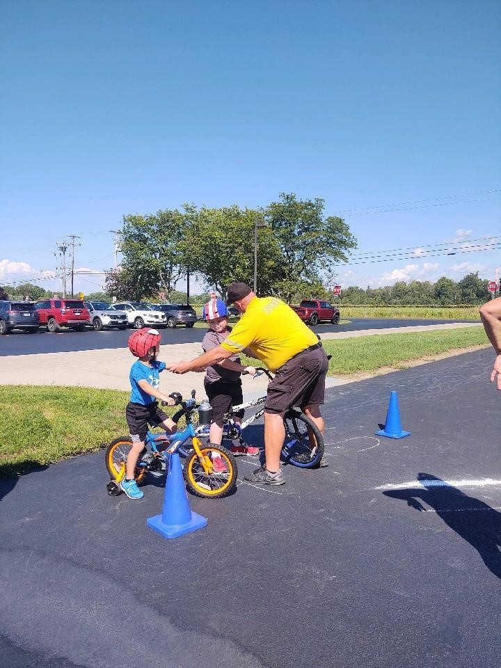 Wes Johnson and two students at the Bike Rodeo in August 2022 