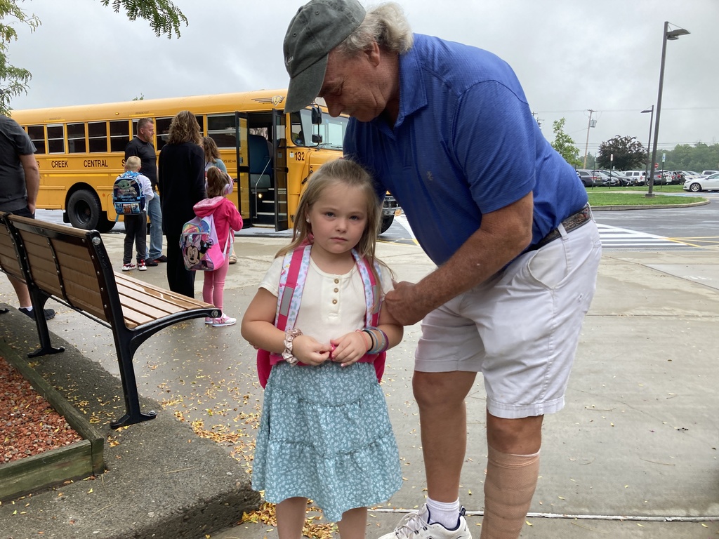 John Charry greets a grandchild on the first day of school 