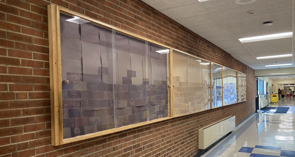 A sidelong view of the future Veterans' Tribute Wall showcase between the high and elementary schools 
