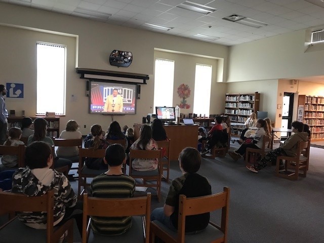 students in the library looking at a screen